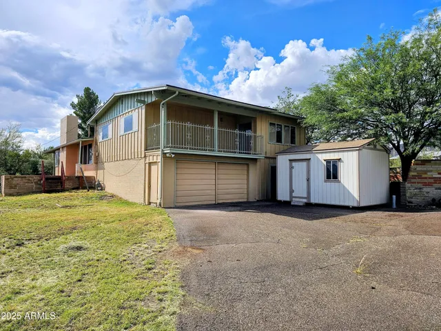 a big house with a big yard and large trees