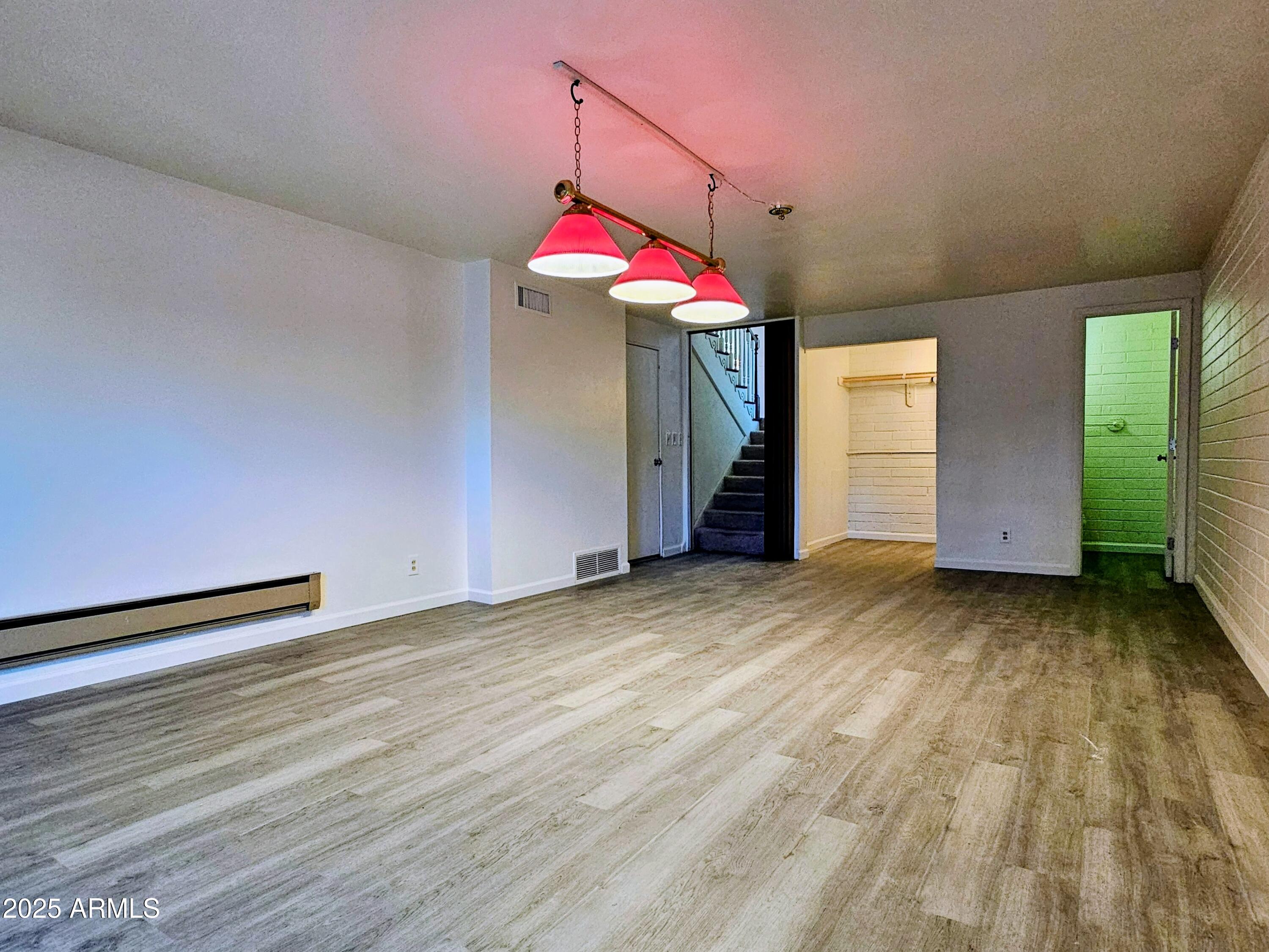 85 Pima Drive Bisbee, AZ 85603 - Photo 33 of 44 an empty room with wooden floor and white walls