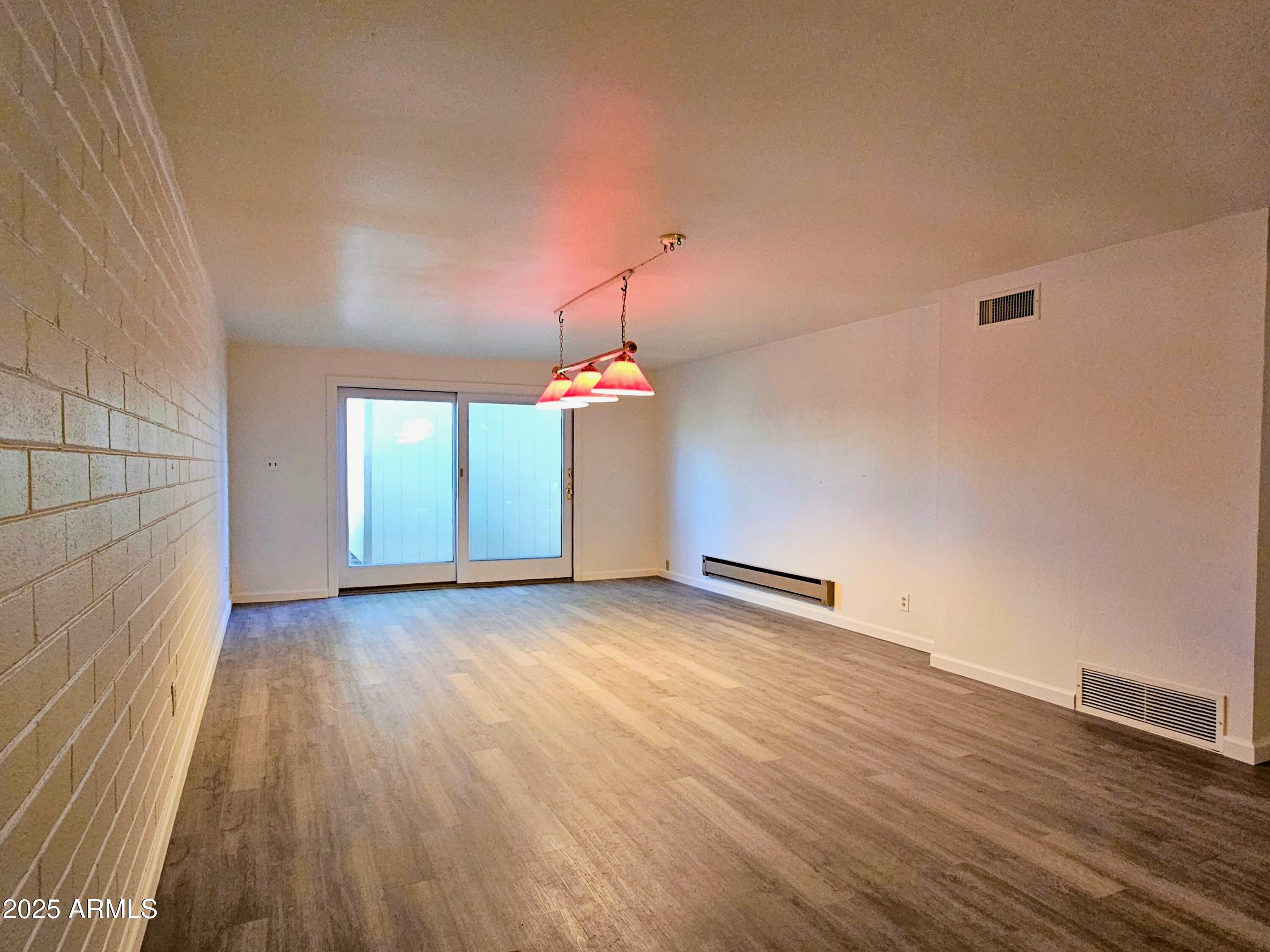 85 Pima Drive Bisbee, AZ 85603 - Photo 34 of 44 an empty room with wooden floor and windows