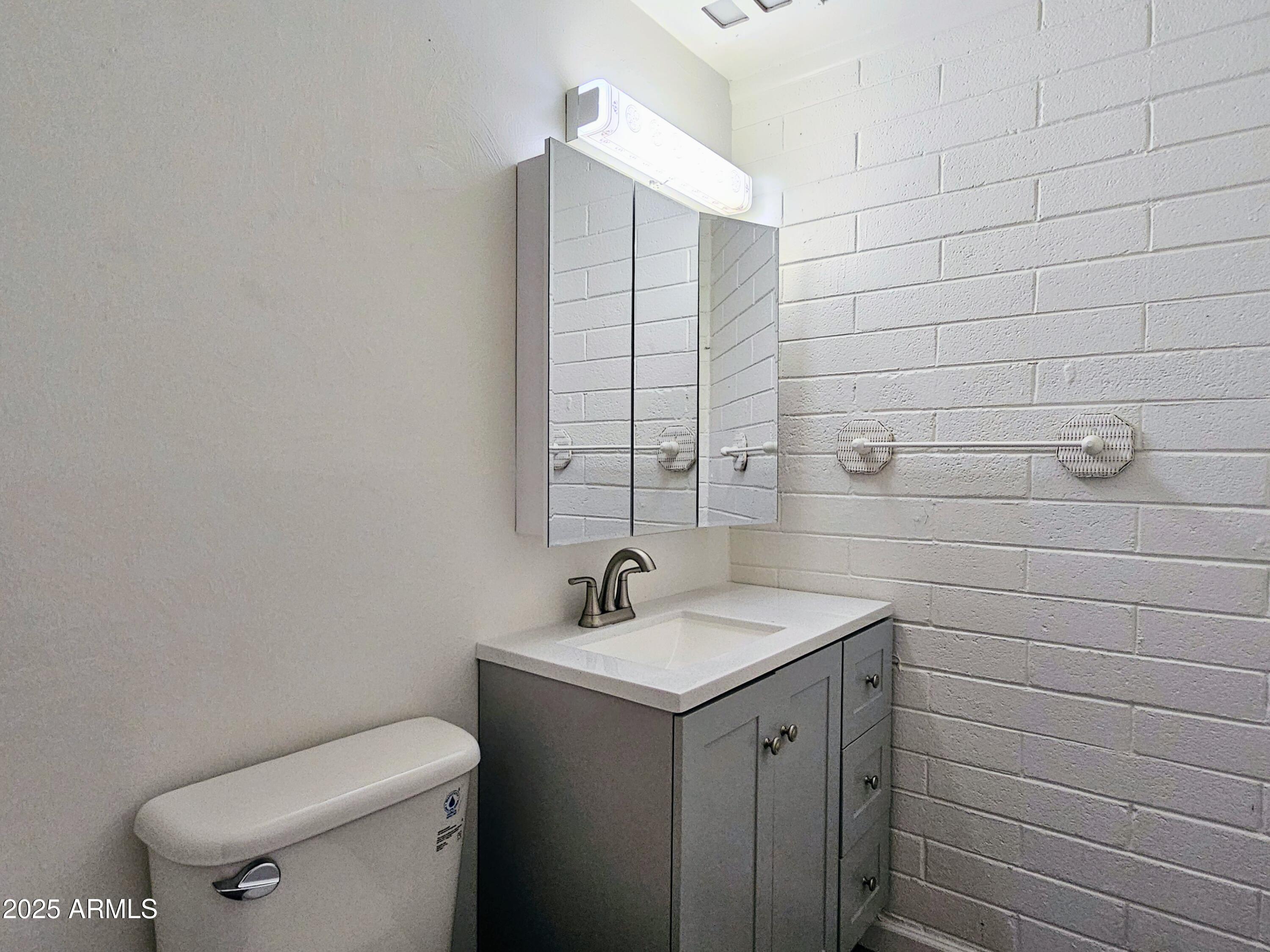 85 Pima Drive Bisbee, AZ 85603 - Photo 35 of 44 a bathroom with a toilet sink and mirror