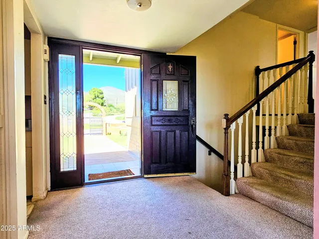 an empty room with windows and a fireplace