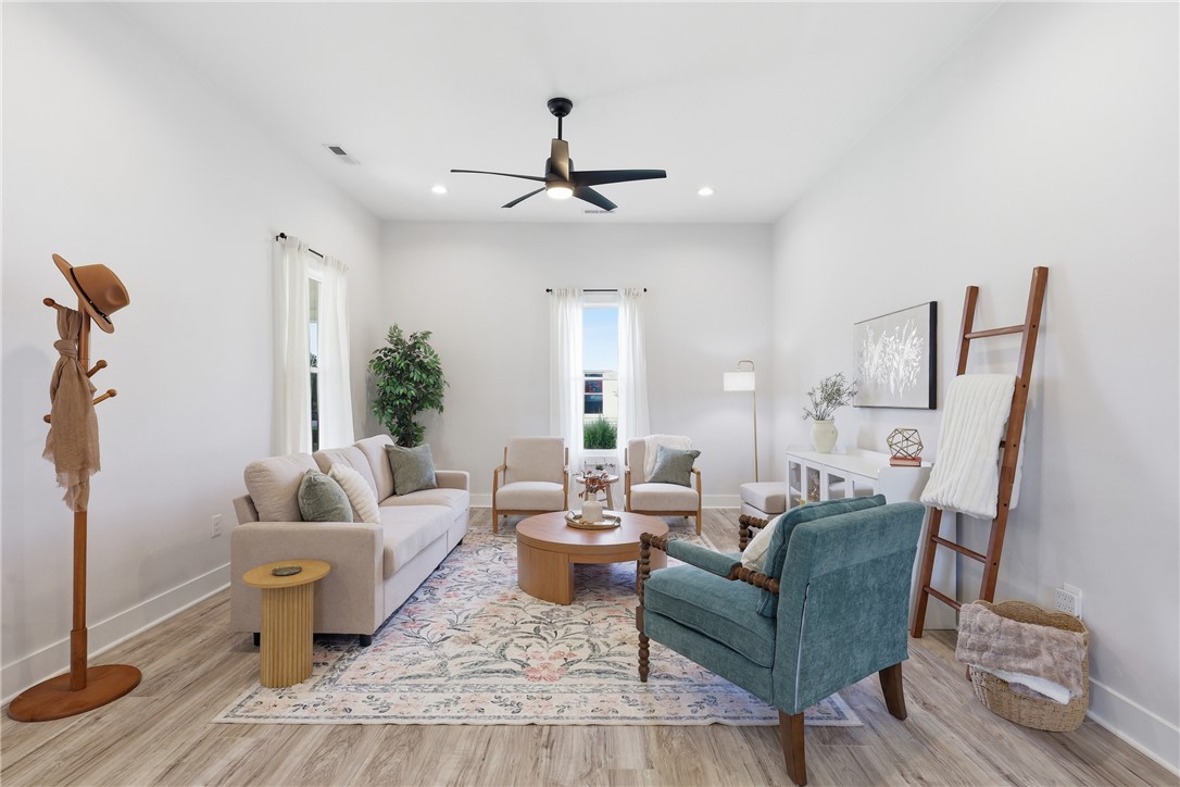 1 Brock Street Pelzer, SC 29669 - Photo 5 of 25 A well-lit living space features high ceilings, a tasteful area rug, and modern recessed lighting.