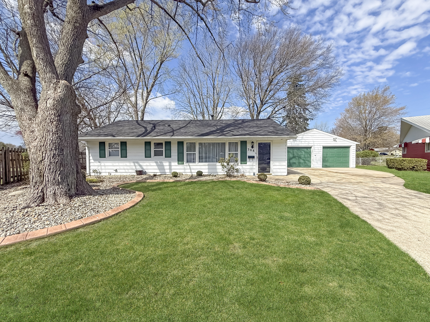 a house view with swimming pool and garden space