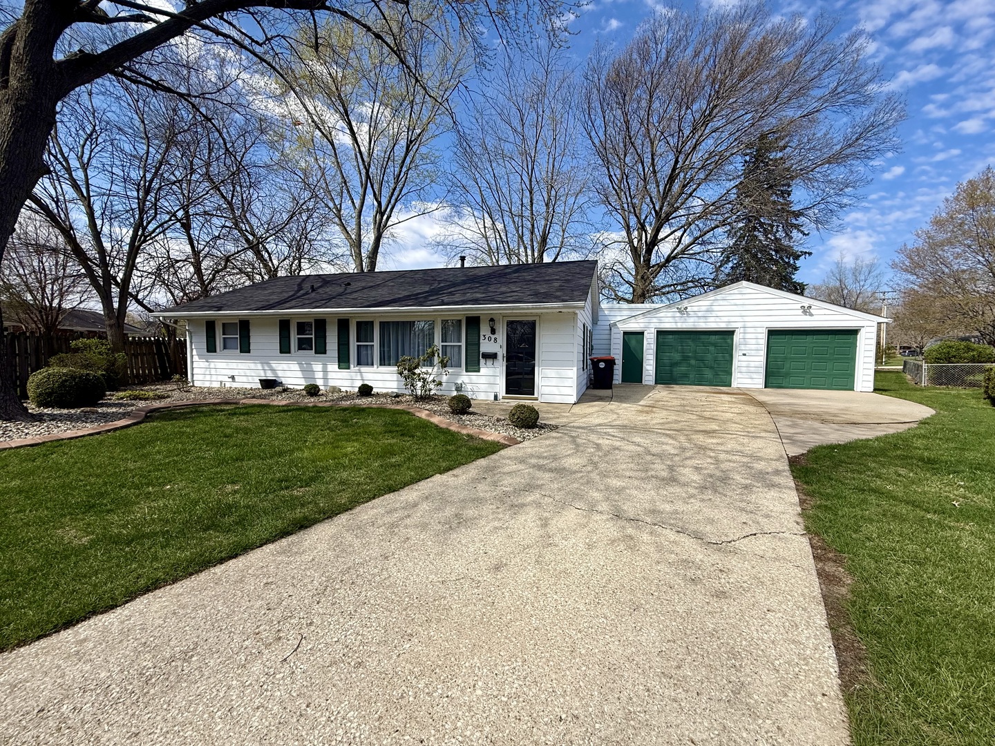 308 Illinois Drive Rantoul, IL 61866 - Photo 2 of 17 a view of a white house with a big yard and large tree