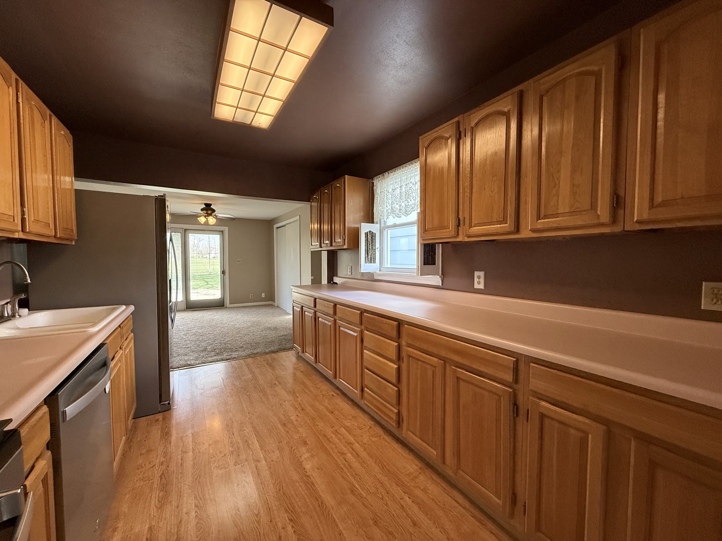 308 Illinois Drive Rantoul, IL 61866 - Photo 4 of 17 a kitchen with stainless steel appliances granite countertop wooden cabinets a sink and dishwasher with wooden floor