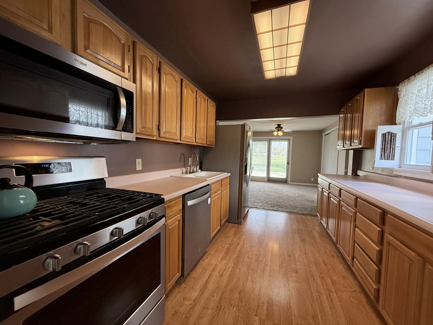 308 Illinois Drive Rantoul, IL 61866 - Photo 5 of 17 a kitchen with wooden cabinets and a stove top oven