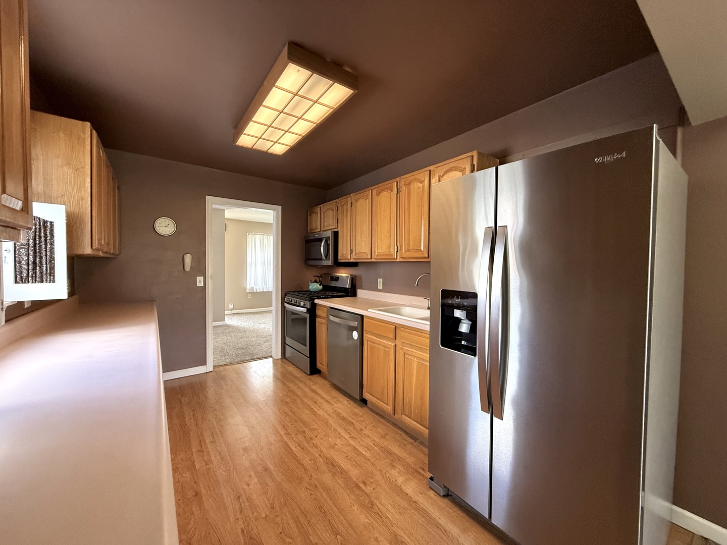 308 Illinois Drive Rantoul, IL 61866 - Photo 6 of 17 a kitchen with granite countertop stainless steel appliances a refrigerator cabinets and wooden floor