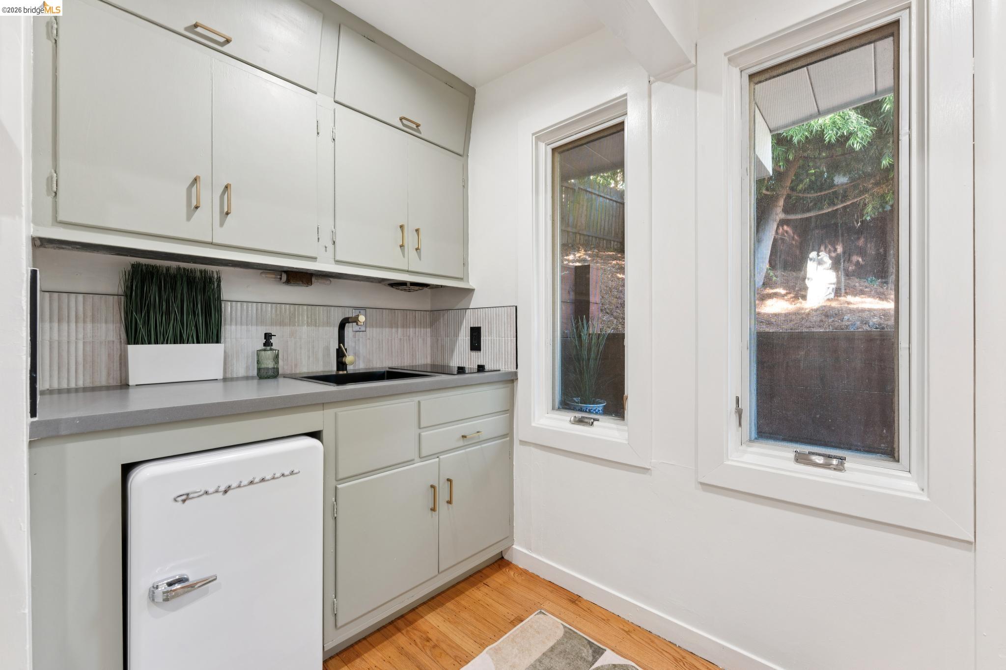 2301 Oak Street Berkeley, CA 94708 - Photo 27 of 61 Utility area featuring a black sink with a matte black faucet, light gray cabinetry, and a light gray countertop