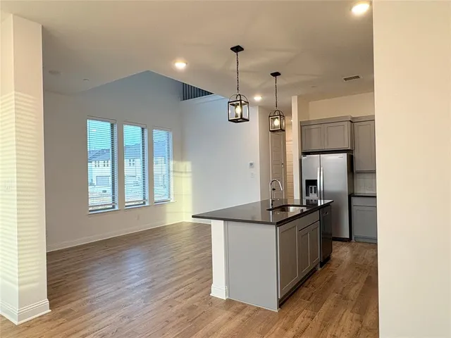 a kitchen with stainless steel appliances granite countertop a stove and a refrigerator