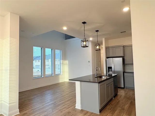 a kitchen with stainless steel appliances granite countertop a refrigerator and a stove