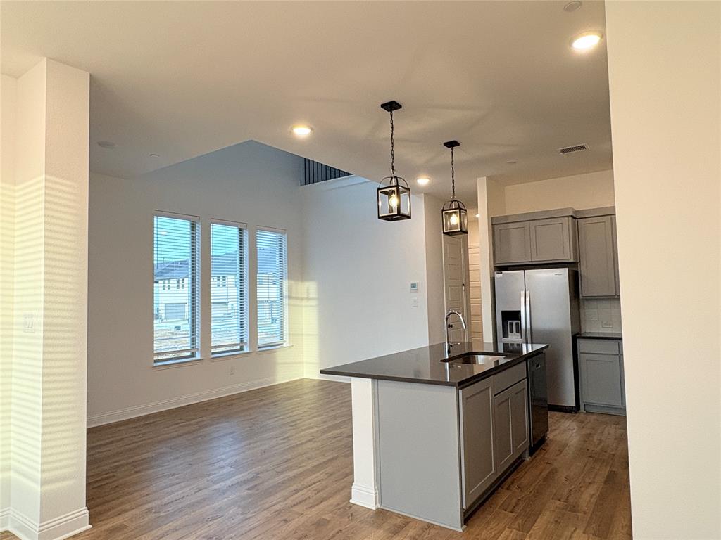 2528 Brunswick Way Allen, TX 75013 - Photo 3 of 8 a kitchen with stainless steel appliances granite countertop a refrigerator and a stove