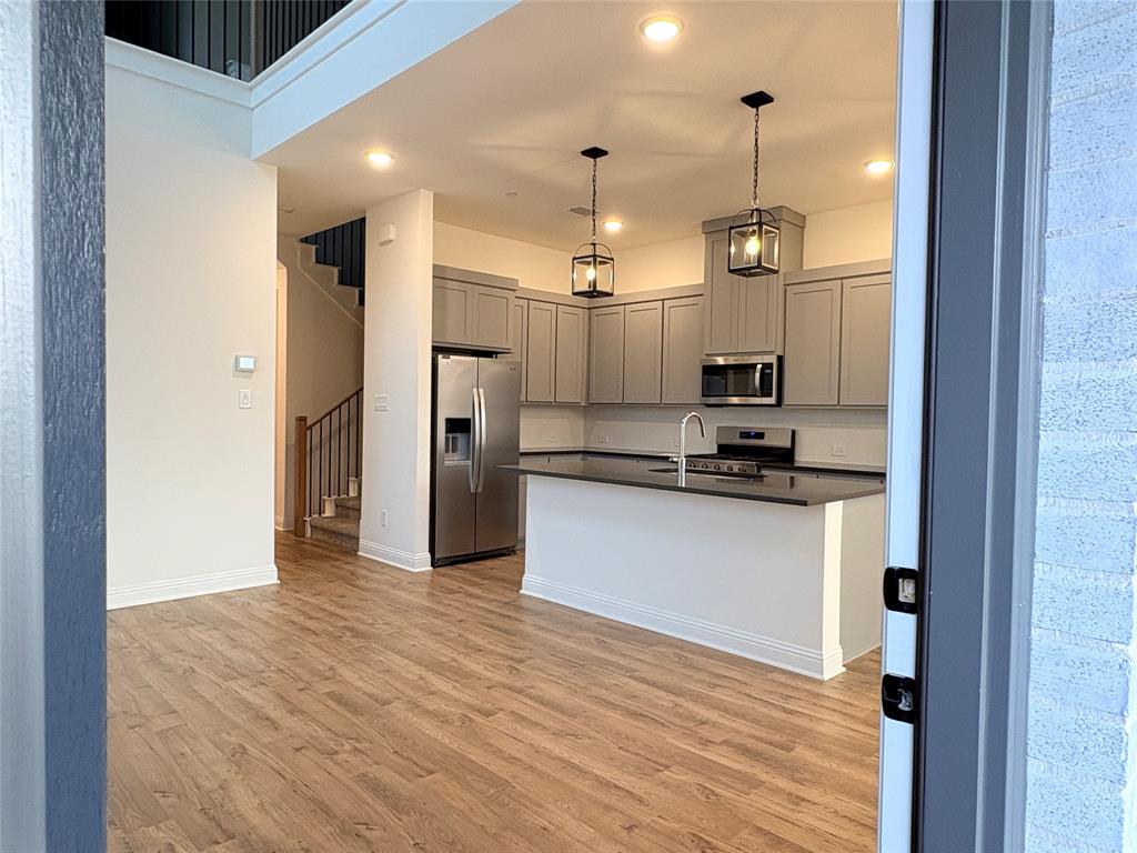 2528 Brunswick Way Allen, TX 75013 - Photo 7 of 8 a view of a kitchen with a refrigerator and a stove top oven