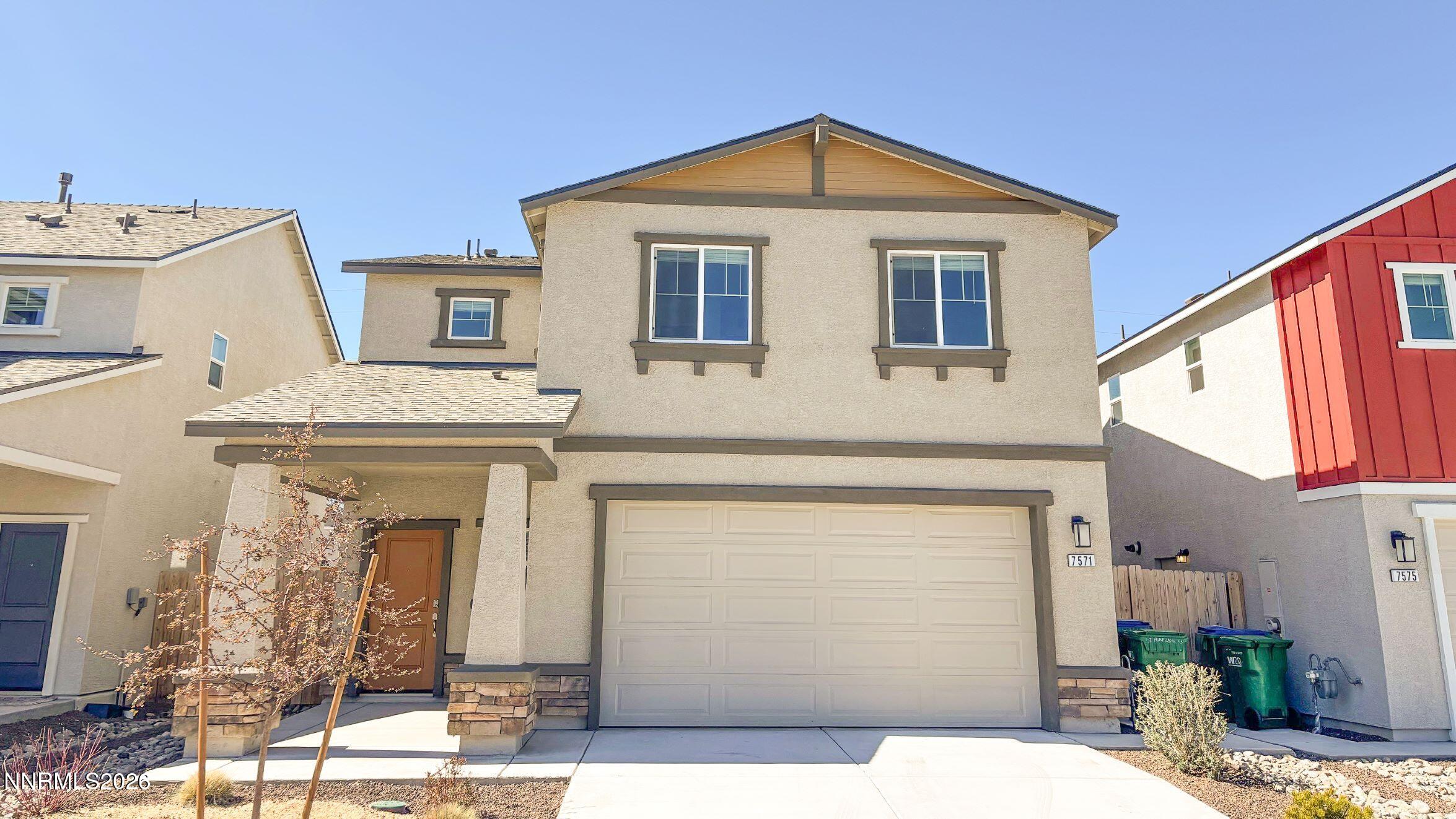 7571 Plump Jack Lane Reno, NV 89506 - Photo 1 of 22 a front view of a house with a garage