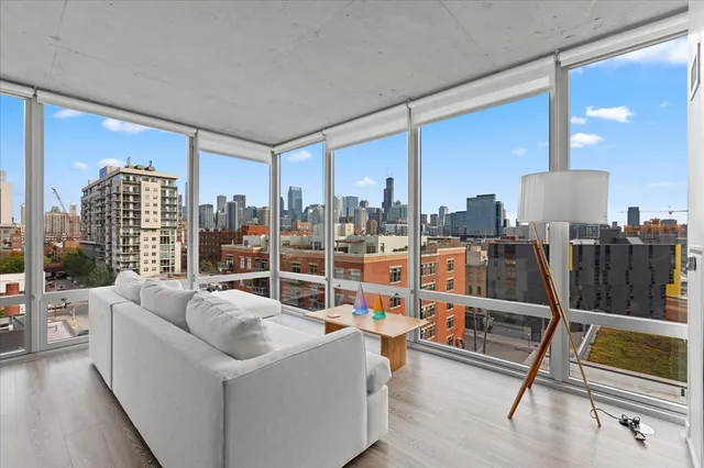 a living room with furniture and a floor to ceiling window