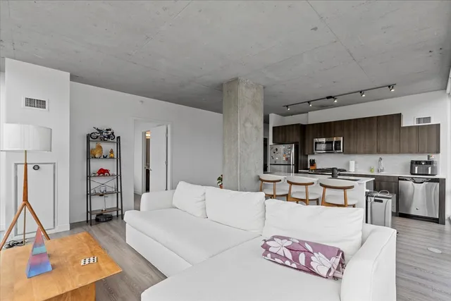 a living room with furniture and kitchen view