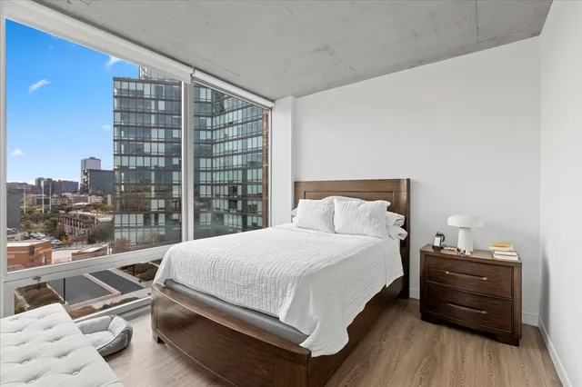 a bedroom with a bed and wooden floor