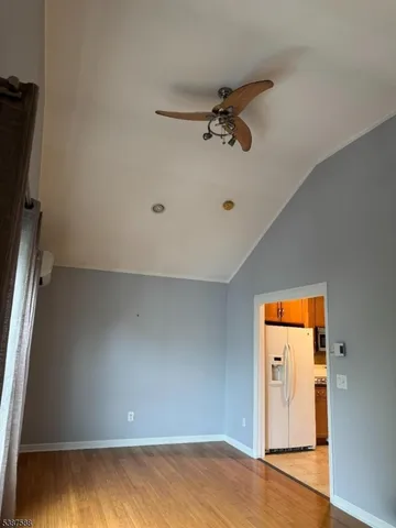 a view of a room with wooden floor and cabinet