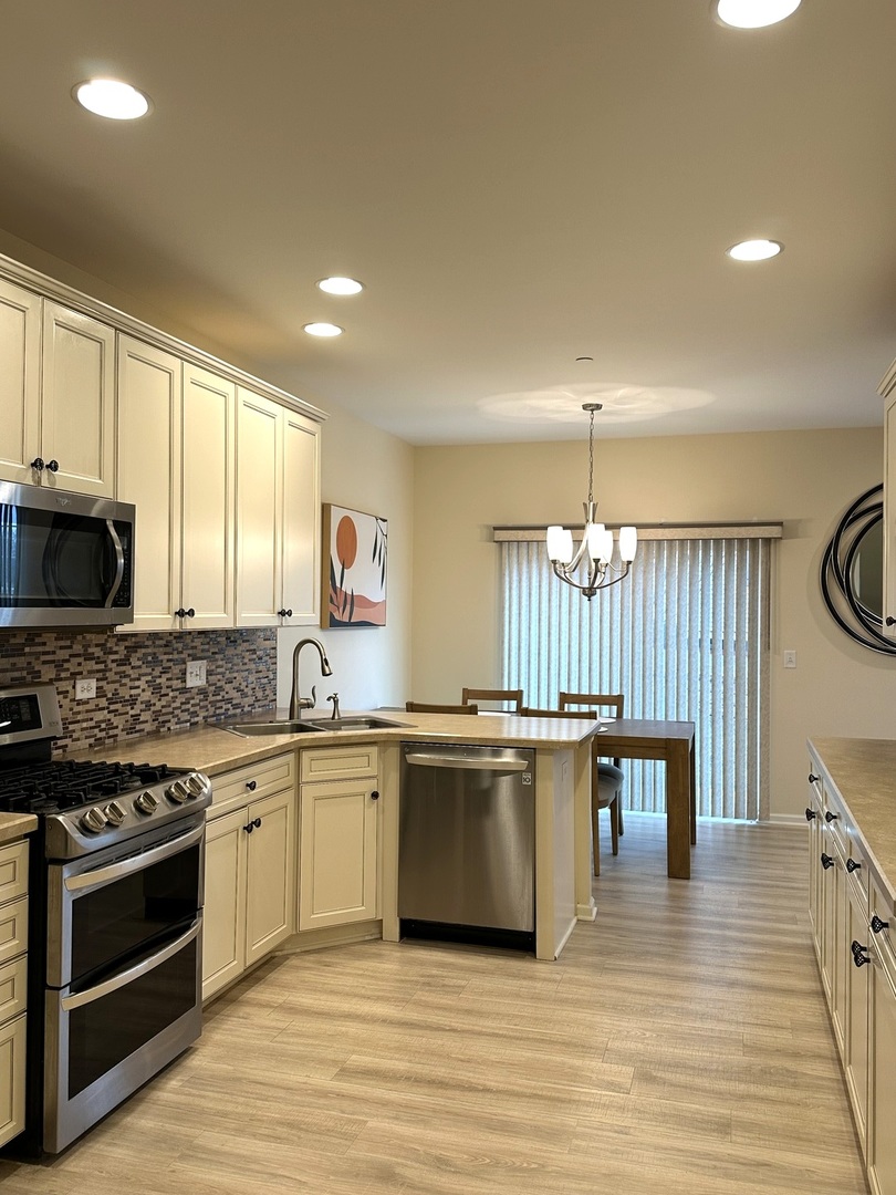 5102 Monroe Street Matteson, IL 60443 - Photo 25 of 54 a kitchen with stainless steel appliances a white stove top oven cabinets a refrigerator and a stove