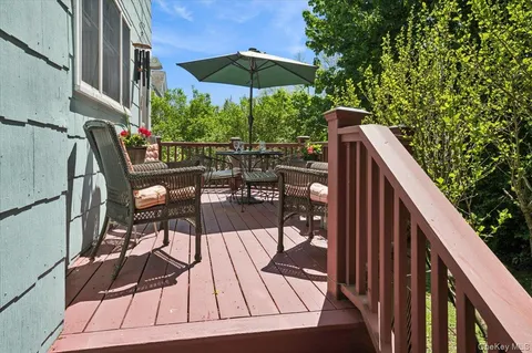 a view of balcony with outdoor seating and wooden floor