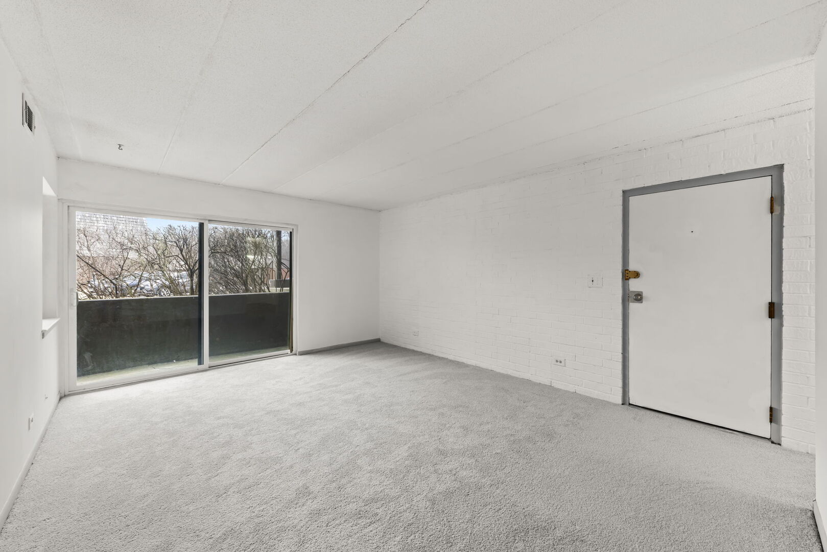 548 Timber Ridge Drive, Unit 108 Carol Stream, IL 60188 - Photo 4 of 18 an empty room with sliding glass door