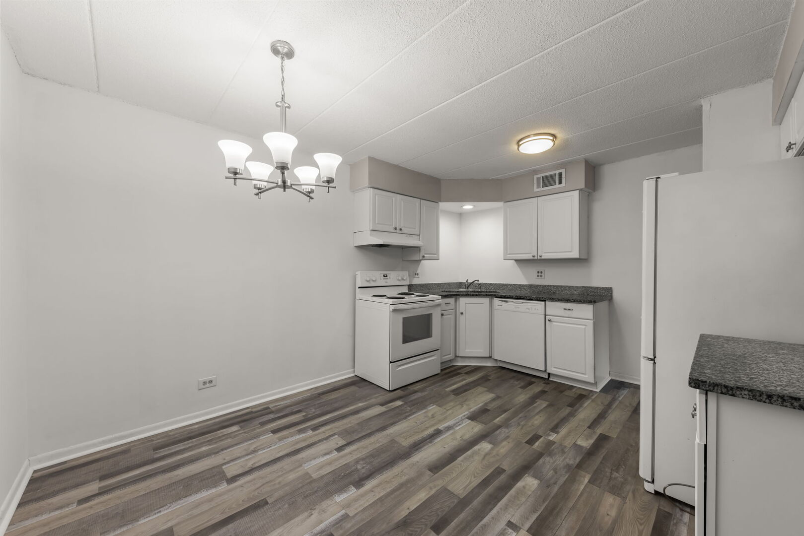 548 Timber Ridge Drive, Unit 108 Carol Stream, IL 60188 - Photo 5 of 18 a kitchen with a refrigerator and a stove top oven