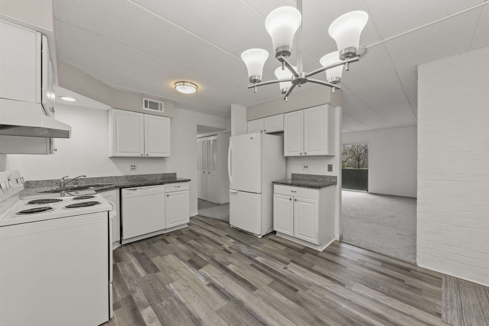 548 Timber Ridge Drive, Unit 108 Carol Stream, IL 60188 - Photo 7 of 18 a kitchen with a stove cabinets and wooden floor