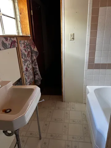 a bathroom with a tub a sink and a toilet