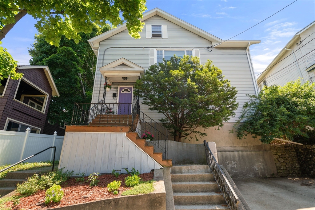 18 Moulton Road, Unit 1 Arlington, MA 02476 - Photo 1 of 16 a front view of a house with a garden