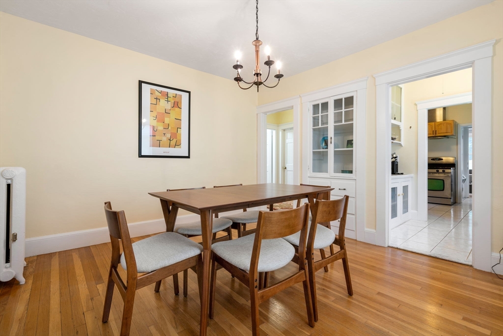 18 Moulton Road, Unit 1 Arlington, MA 02476 - Photo 3 of 16 a dining room with wooden floor and a chandelier