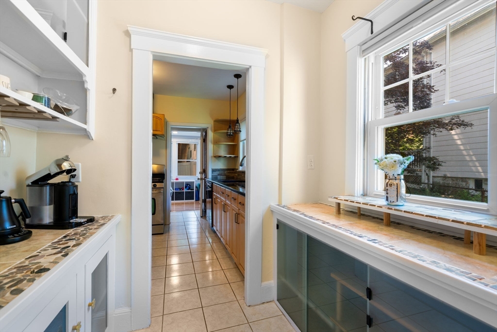 18 Moulton Road, Unit 1 Arlington, MA 02476 - Photo 4 of 16 a kitchen with granite countertop a sink and a stove