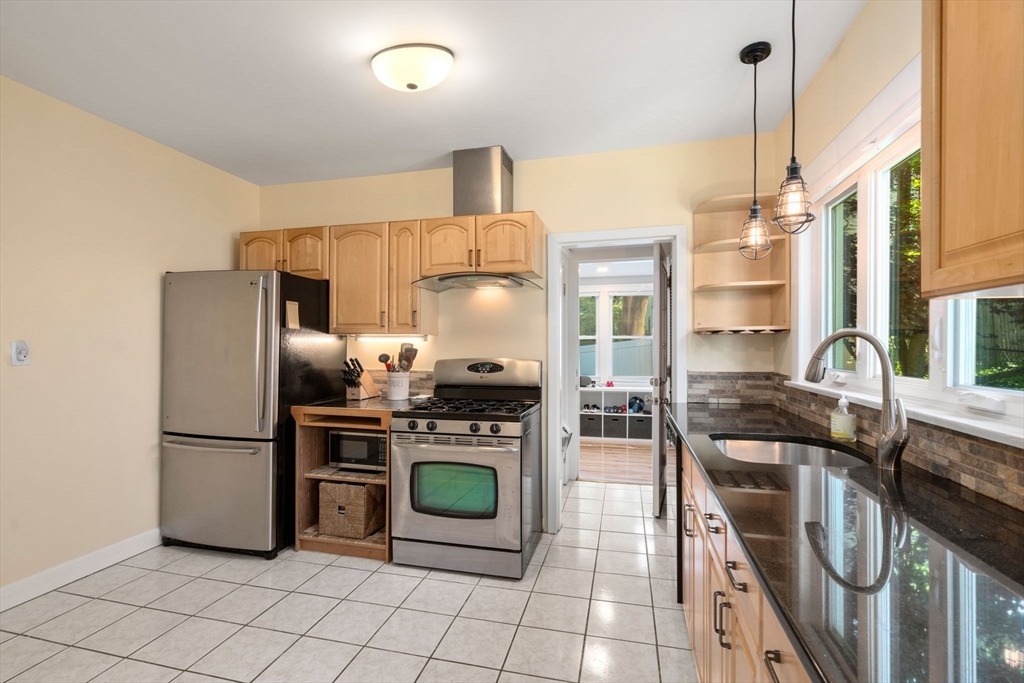 18 Moulton Road, Unit 1 Arlington, MA 02476 - Photo 5 of 16 a kitchen with stainless steel appliances granite countertop a refrigerator a stove and a sink