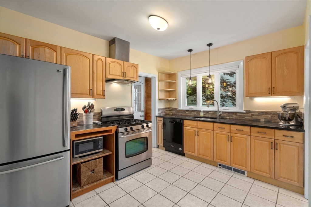 18 Moulton Road, Unit 1 Arlington, MA 02476 - Photo 6 of 16 a kitchen with stainless steel appliances granite countertop a refrigerator sink and stove