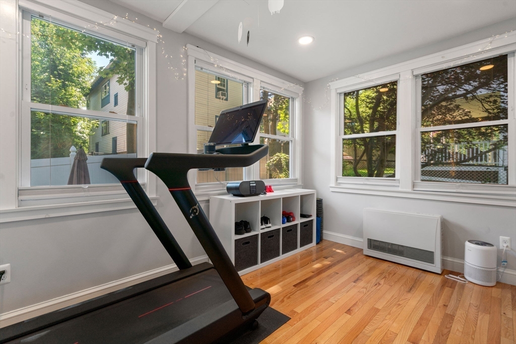 18 Moulton Road, Unit 1 Arlington, MA 02476 - Photo 7 of 16 a view of a room with wooden floor and windows