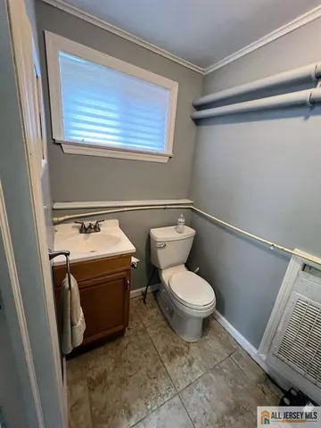 a bathroom with a toilet and a window