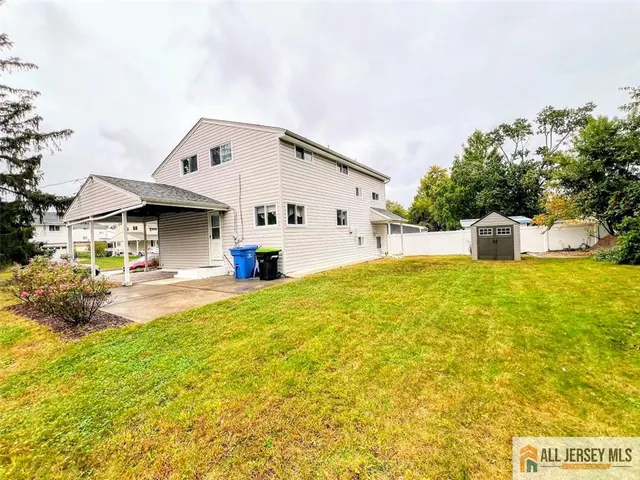 a view of a house with pool and a yard