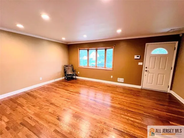 a view of a room with a wooden floor and a window