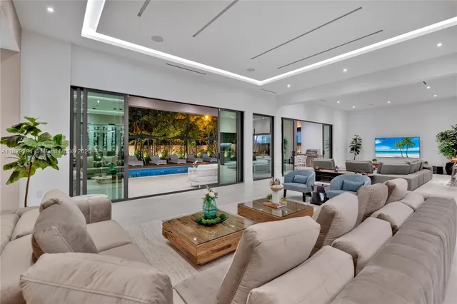 a view of a dining room with furniture and a floor to ceiling window