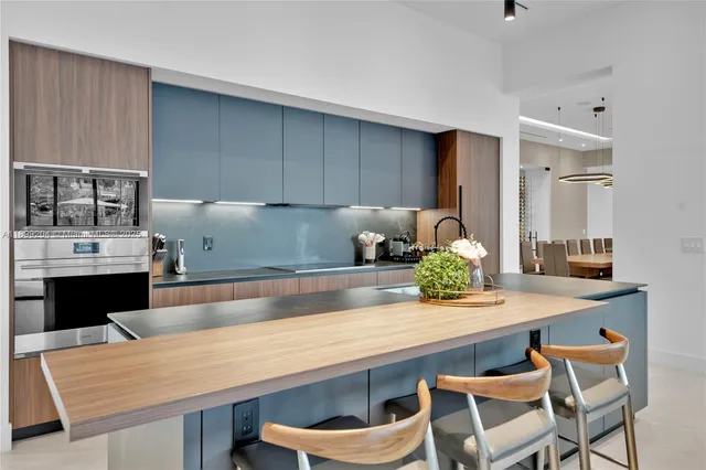 a view of a patio with couches table and chairs and potted plants