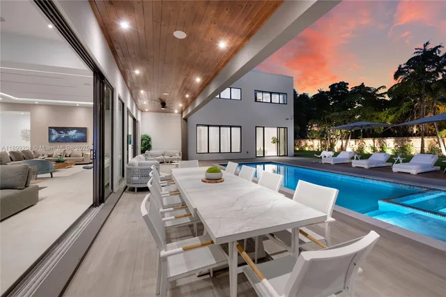 a view of swimming pool outdoor seating and city view