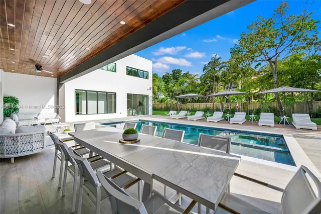 a bedroom with a bed and glass wall