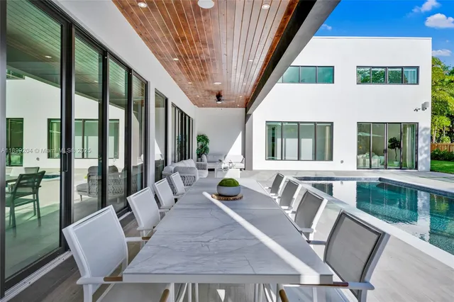 a bedroom with a large bed and a potted plant