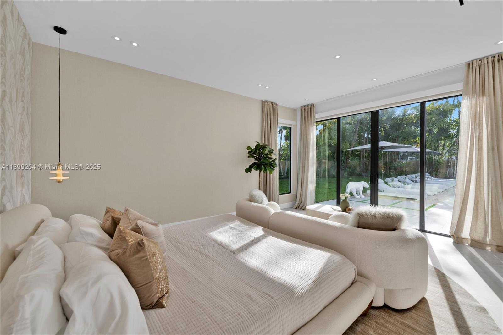 2110 Northeast 197th Terrace Miami, FL 33179 - Photo 30 of 77 a bedroom with a bed and a large window