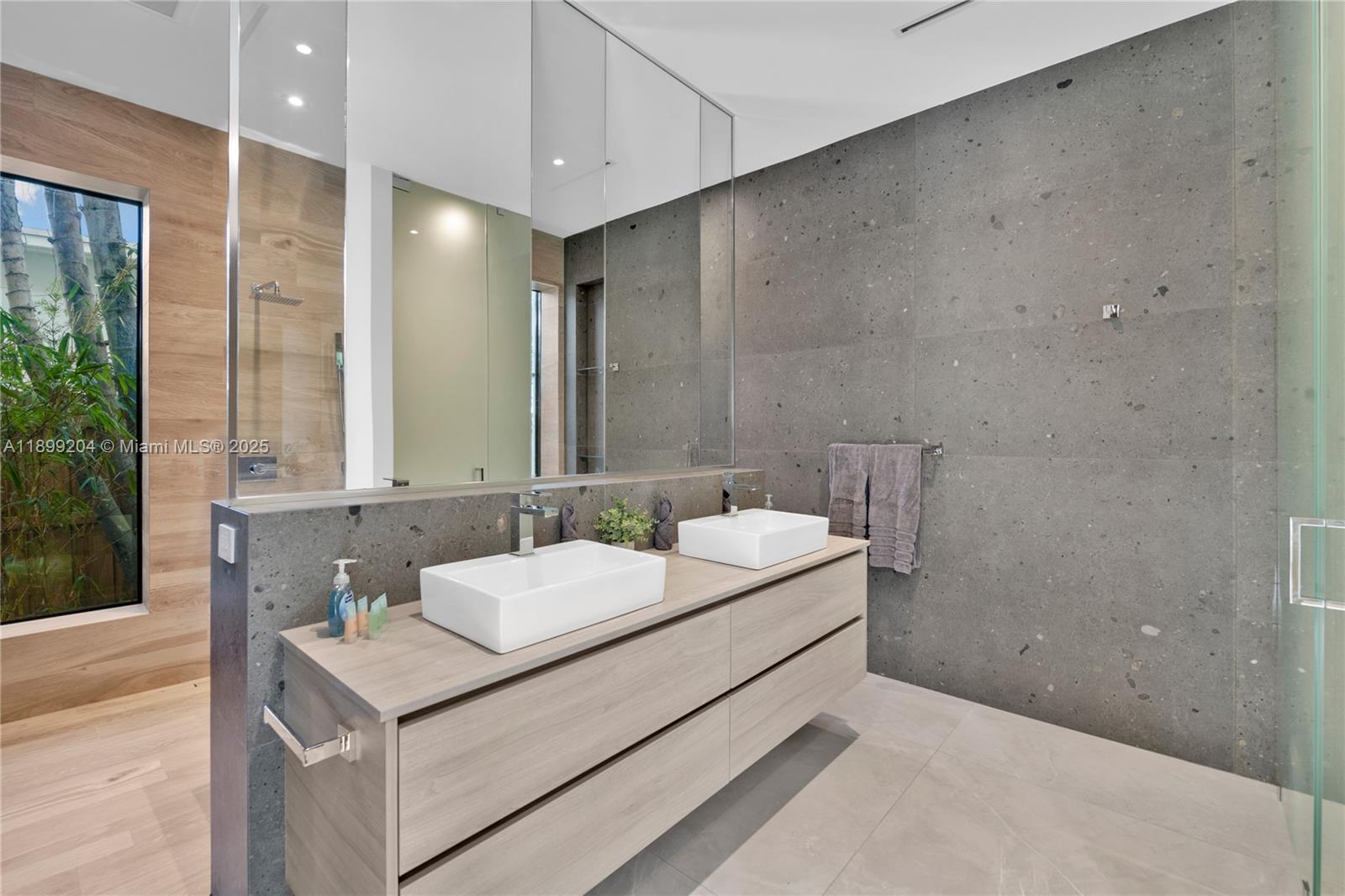 2110 Northeast 197th Terrace Miami, FL 33179 - Photo 32 of 77 a bathroom with a sink and a mirror