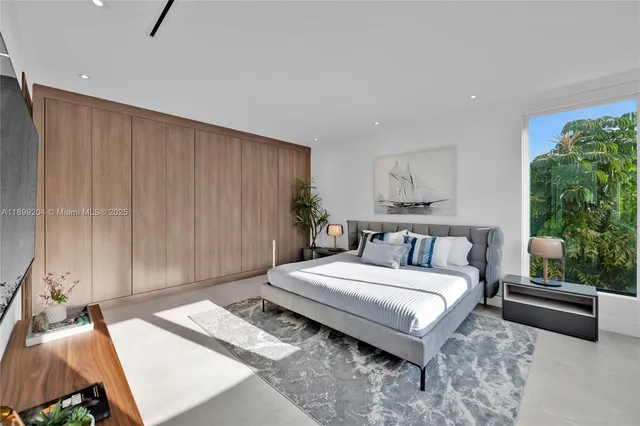 a bedroom with a bed and painting on the wall