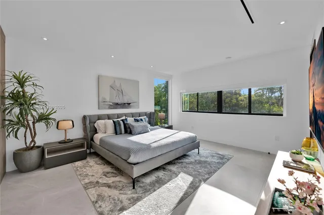 a bedroom with a bed and a potted plant