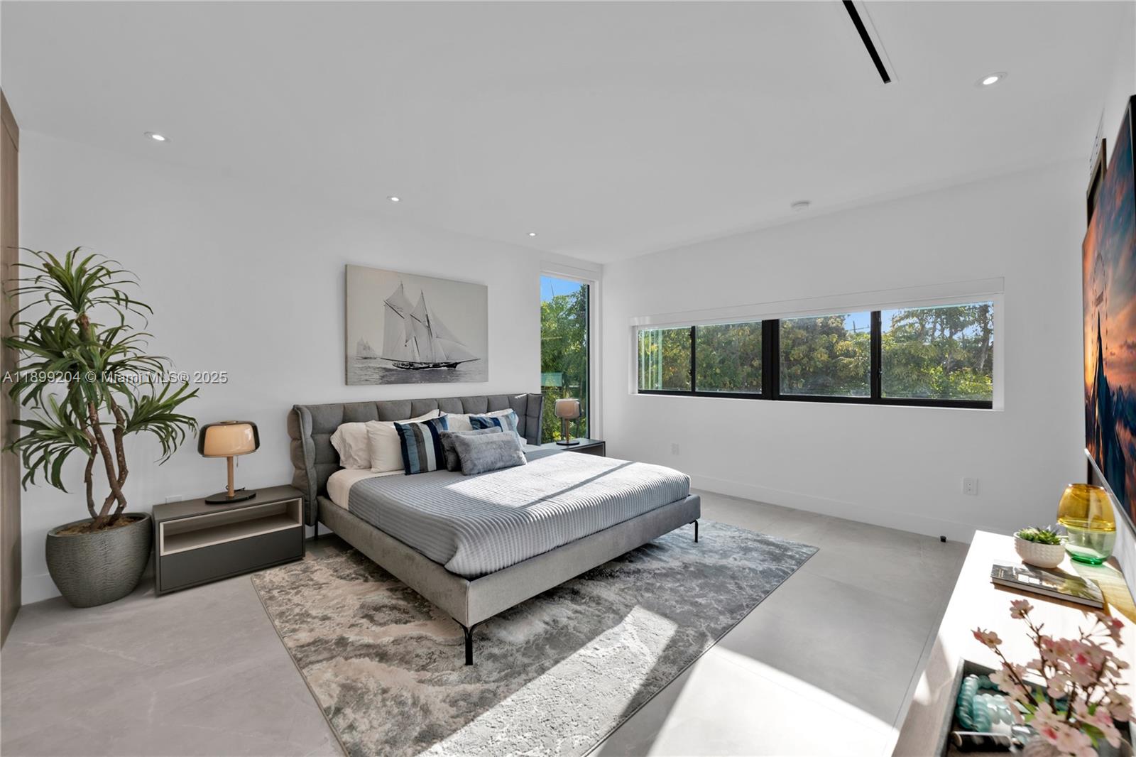 2110 Northeast 197th Terrace Miami, FL 33179 - Photo 40 of 77 a bedroom with a large bed and a couch