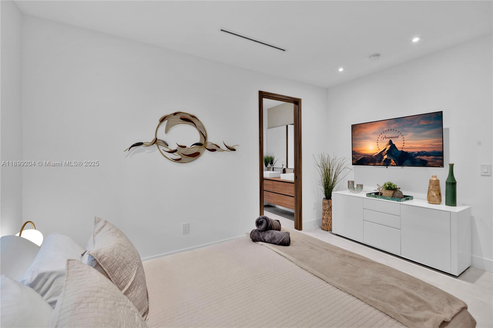 2110 Northeast 197th Terrace Miami, FL 33179 - Photo 45 of 77 a bedroom with a bed and a flat screen tv