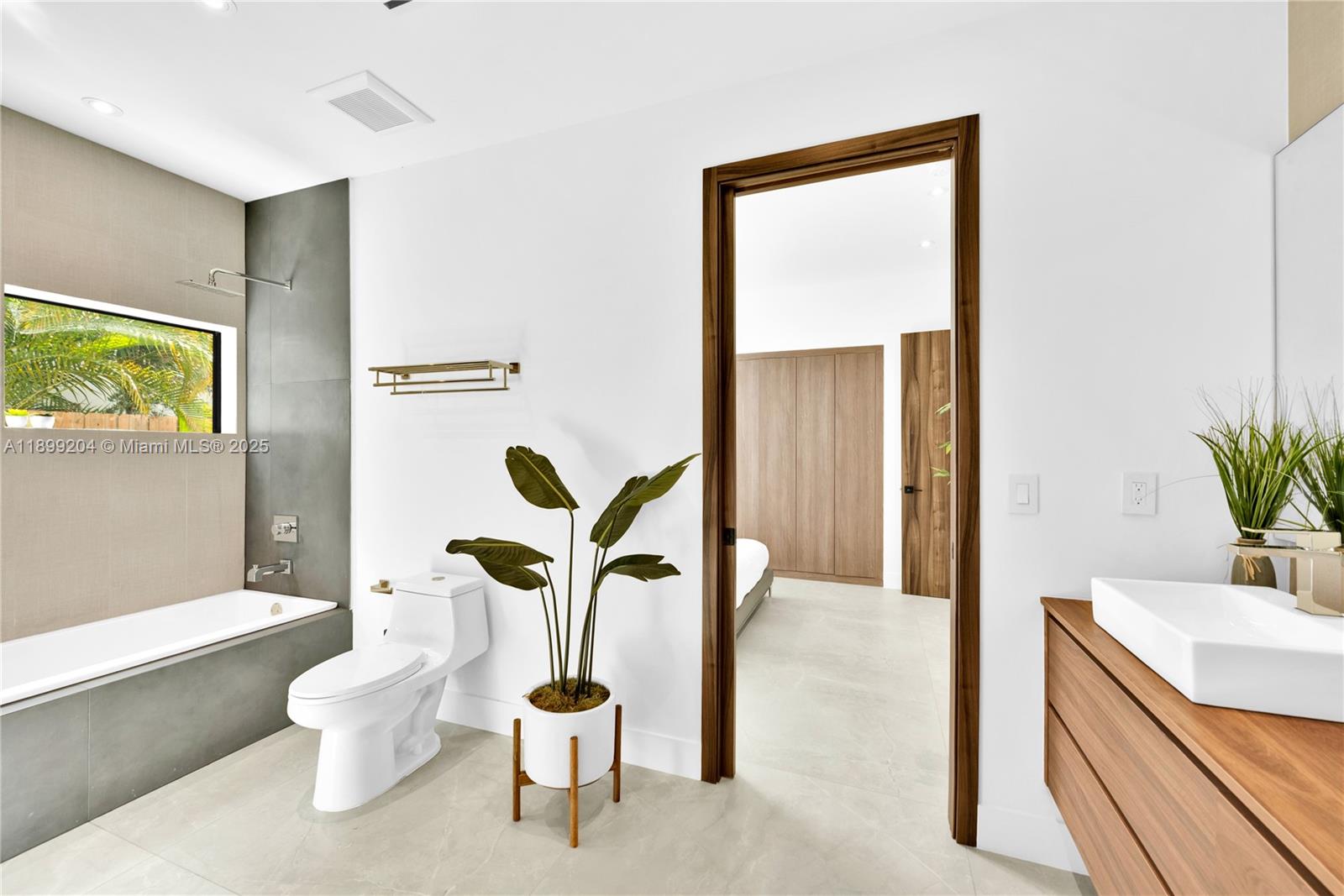 2110 Northeast 197th Terrace Miami, FL 33179 - Photo 47 of 77 a bathroom with a sink mirror vanity and toilet