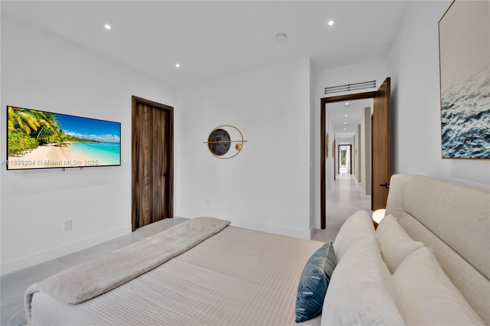 2110 Northeast 197th Terrace Miami, FL 33179 - Photo 49 of 77 a bedroom with a bed and a painting on the wall