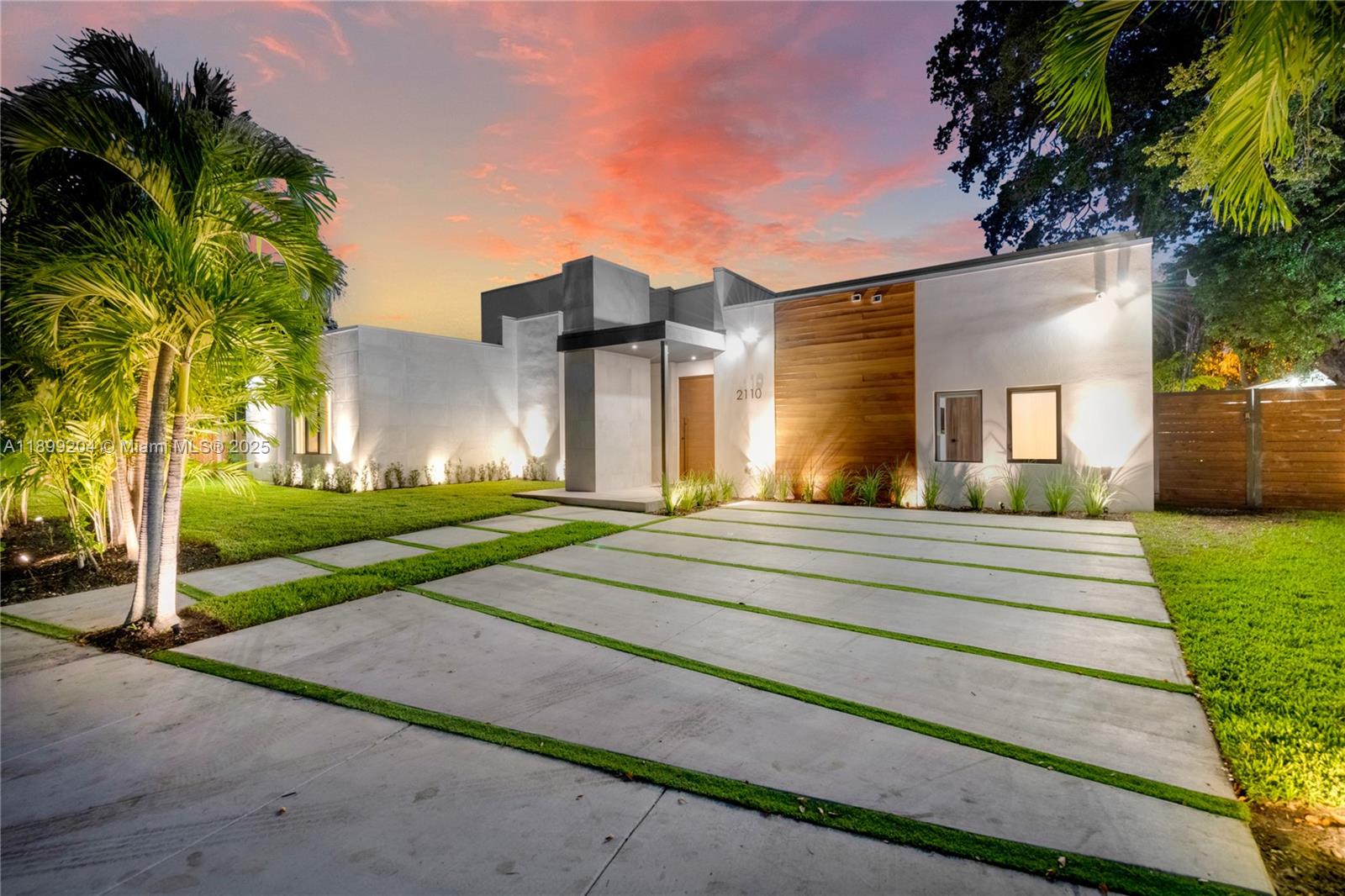 2110 Northeast 197th Terrace Miami, FL 33179 - Photo 5 of 77 a view of a house with a yard and palm trees